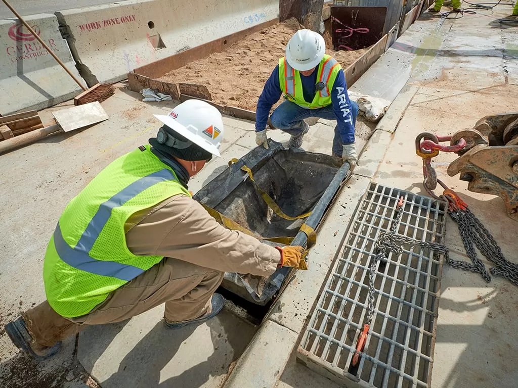 two team members preparing to pour concrete