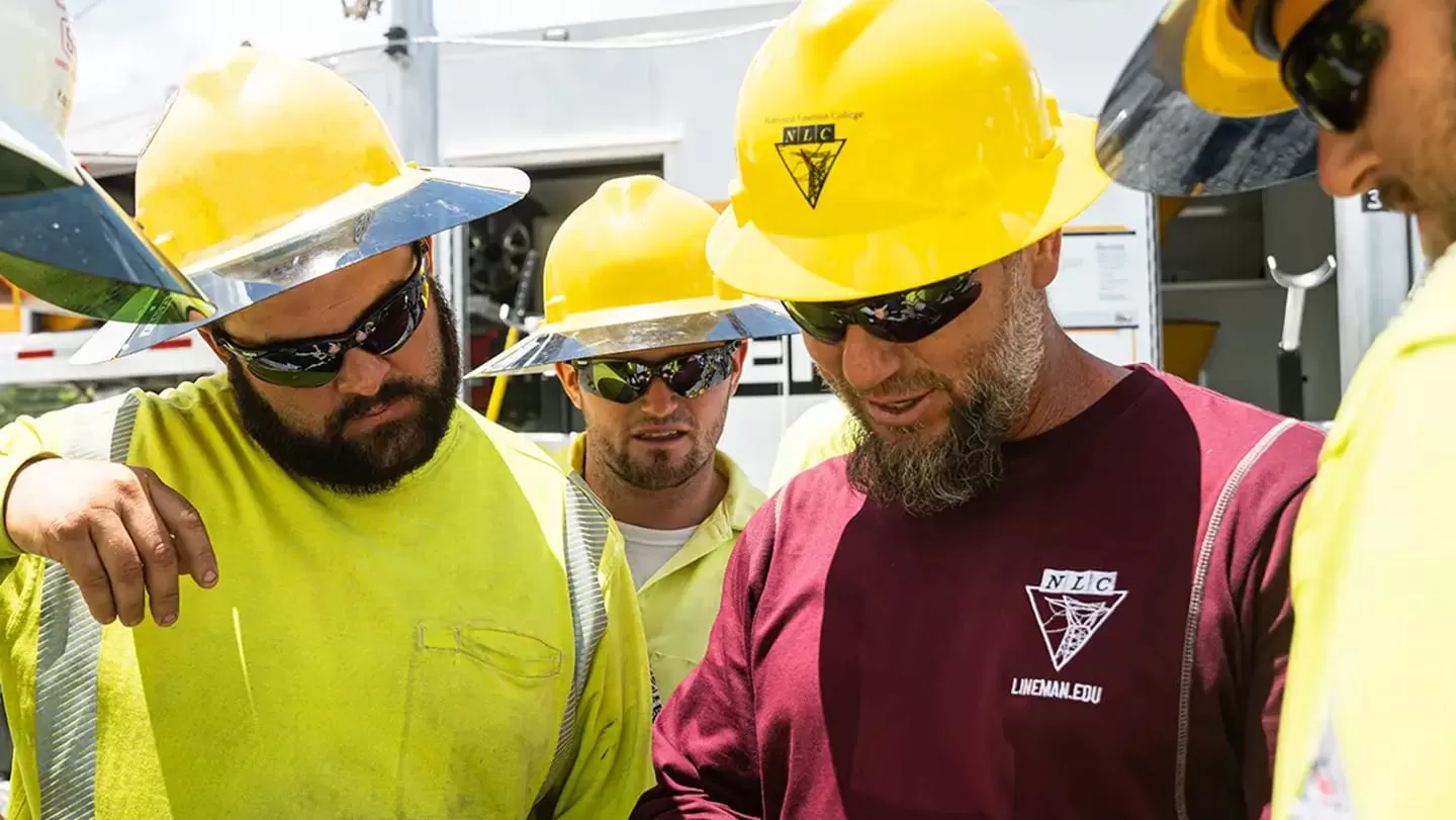 several students discuss plans at Lineman college