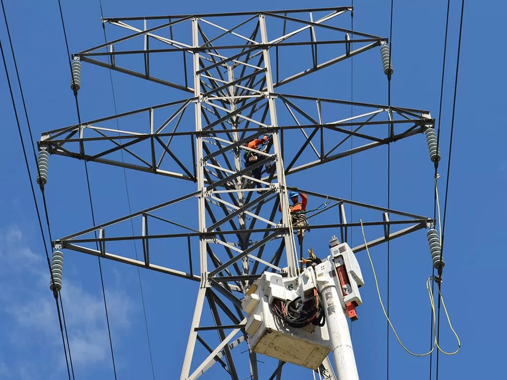 Crew member works on a transmission tower