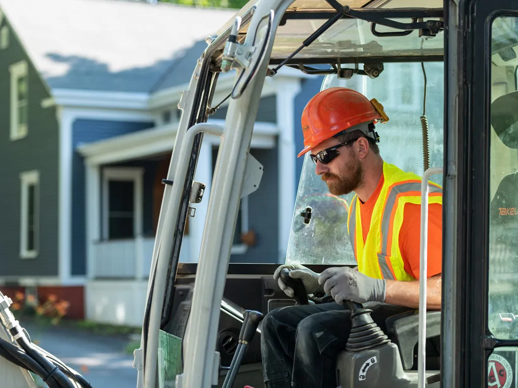 Operator working tractor in residential worksite