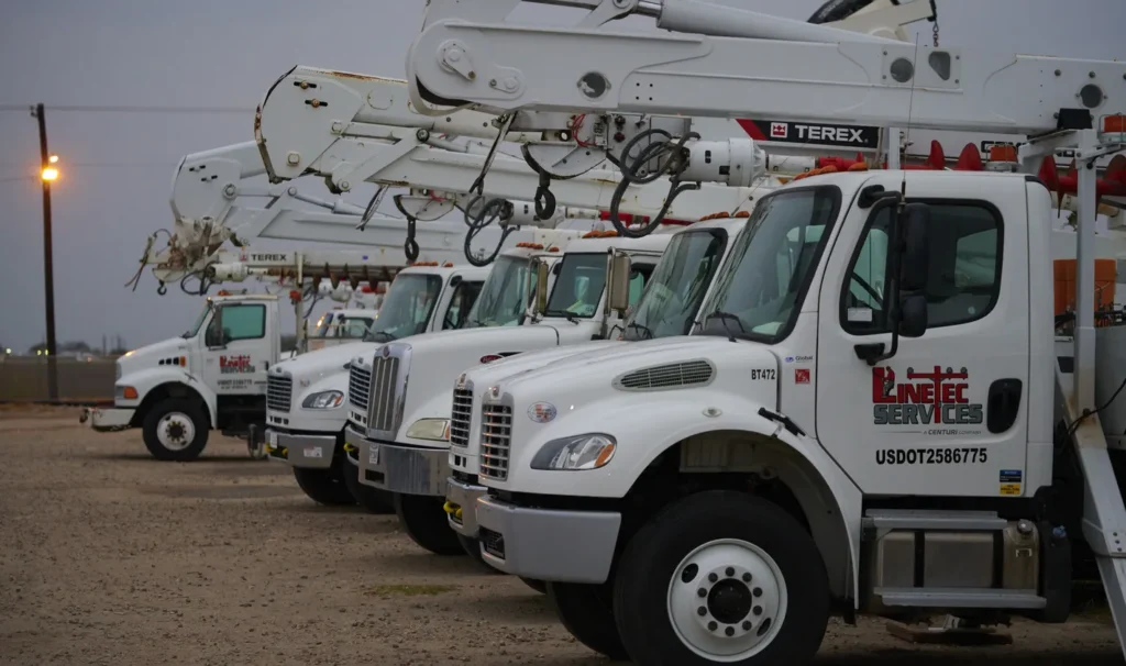 a line of six crane trucks
