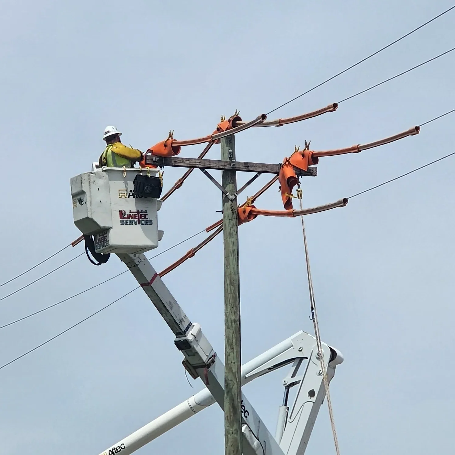 one worker on powerlines